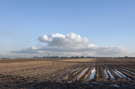 Luchthaven Schiphol achter de uitgestrekte weilanden